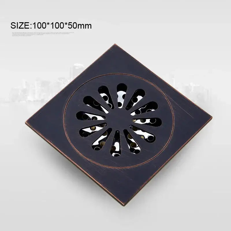 Square-shaped bronze-finished brass floor drain with circular petal pattern from decorbites black anti-odor series