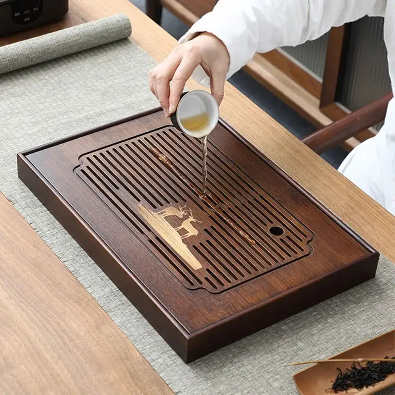 Dark brown bamboo tea tray with carved deer and tree design for dining room drainage and tea serving purposes