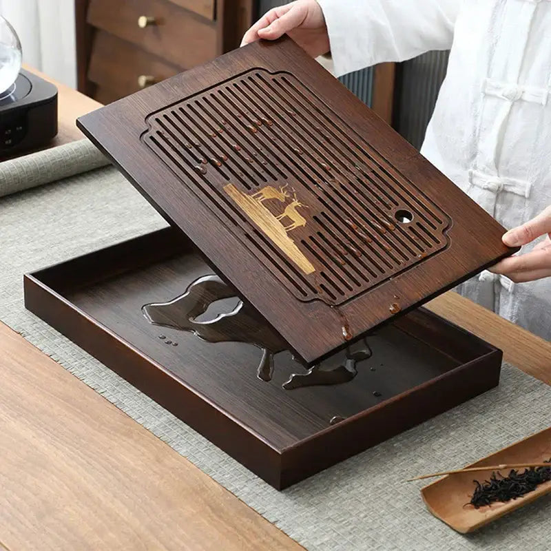 Dark brown bamboo tea tray with carved deer design and slotted drainage board for dining room use