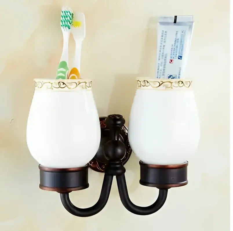 White ceramic toothbrush holder with gold trimmed rim and dark bronze bracket from decorbites carved flowers blackened copper set