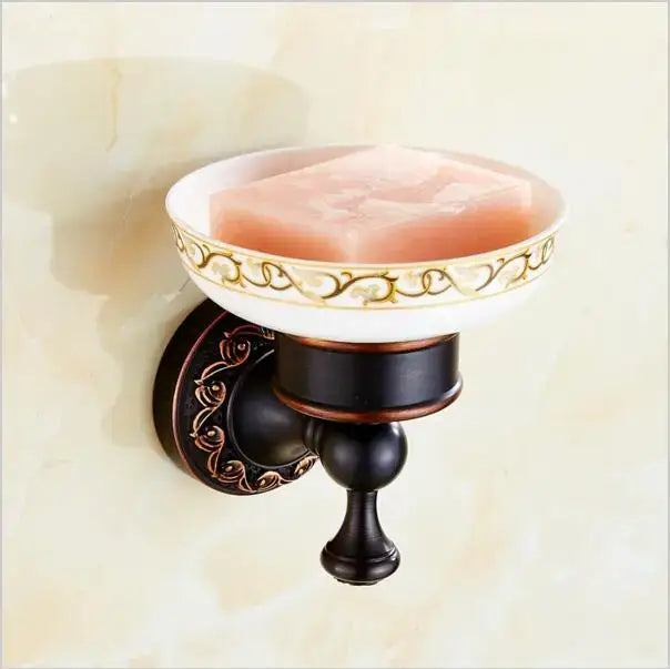 Antique bronze-finished wall-mounted soap dish with white and gold ceramic bowl holding pink soap from decorbites carved flowers blackened copper set