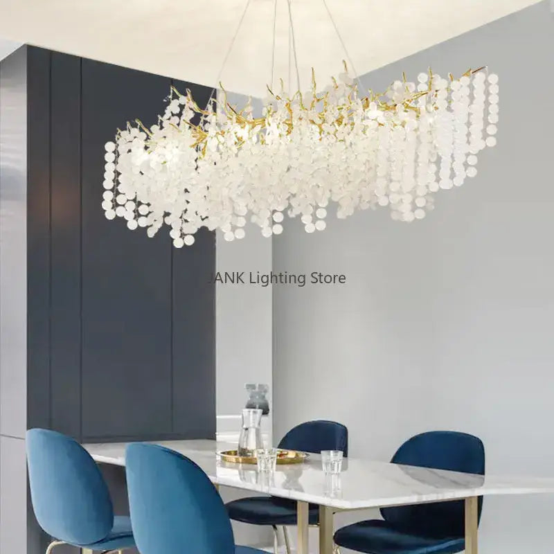 A modern crystal chandelier with a gold-toned frame and cascading white discs for elegant living room decorbites circular crystal design