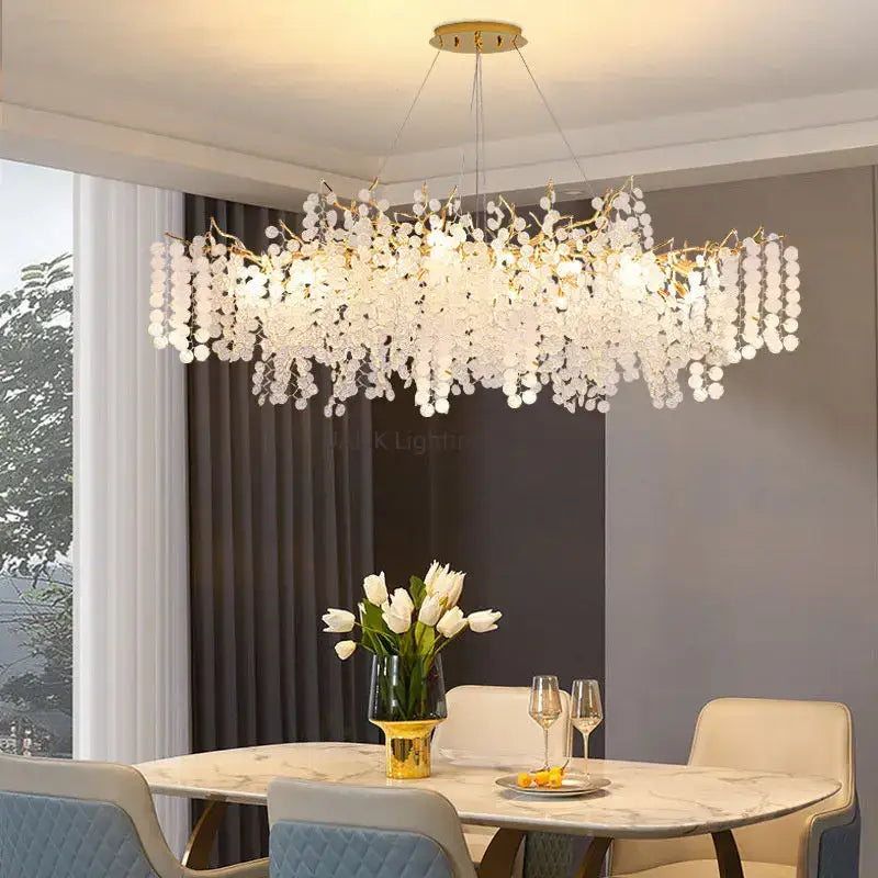 Elegant gold-toned decorbites circular crystal chandelier with cascading white crystal droplets for living room decor