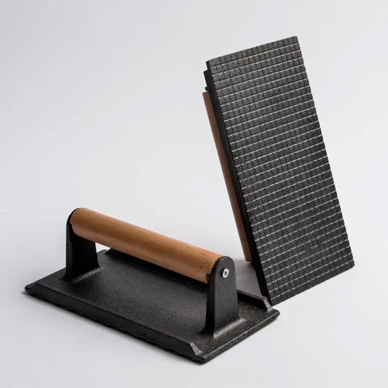 Black cast iron steak press plate with wooden handle and textured grilling surface for kitchen meat tool use