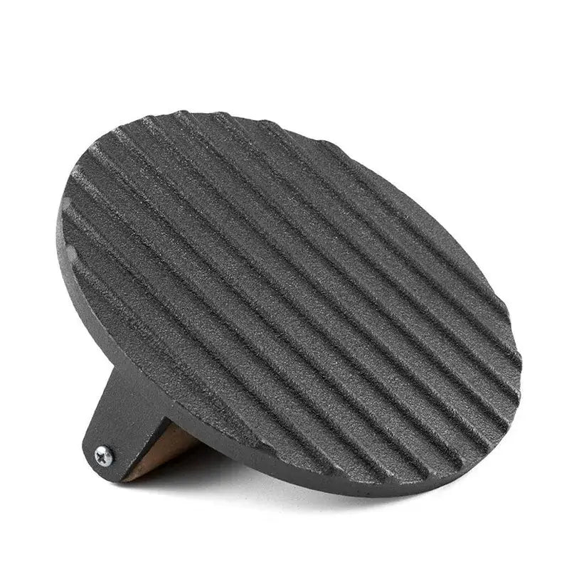 Black cast iron steak press plate with ribbed cooking surface and wooden handle for even grilling and pressing steaks