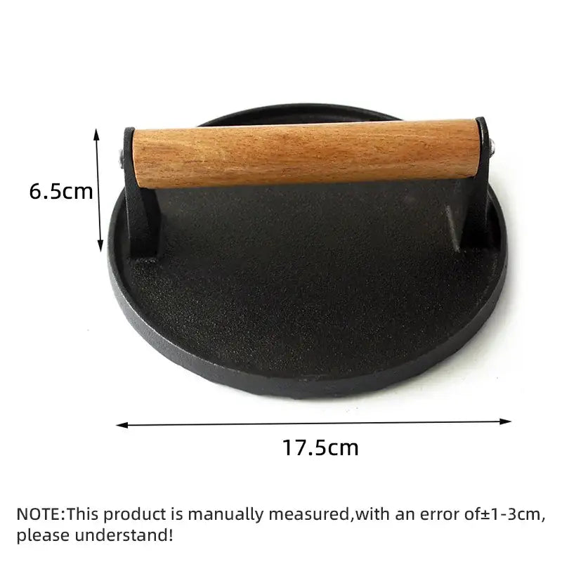 Black cast iron steak press plate with light brown wooden handle for kitchen use cooking burgers or steaks