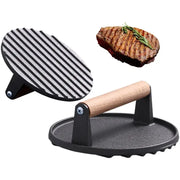 Black cast iron steak press plate with wooden handle and ribbed grilling surface for kitchen use