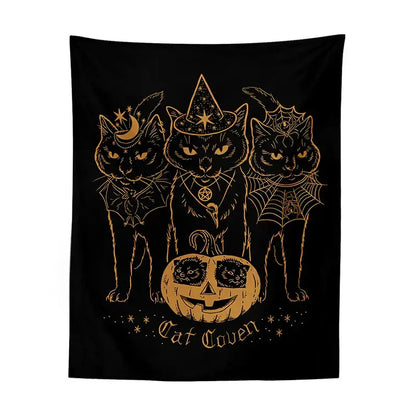 Black tapestry decorbites cat coven with three cats in witchcraft attire and gold foil details around a carved pumpkin