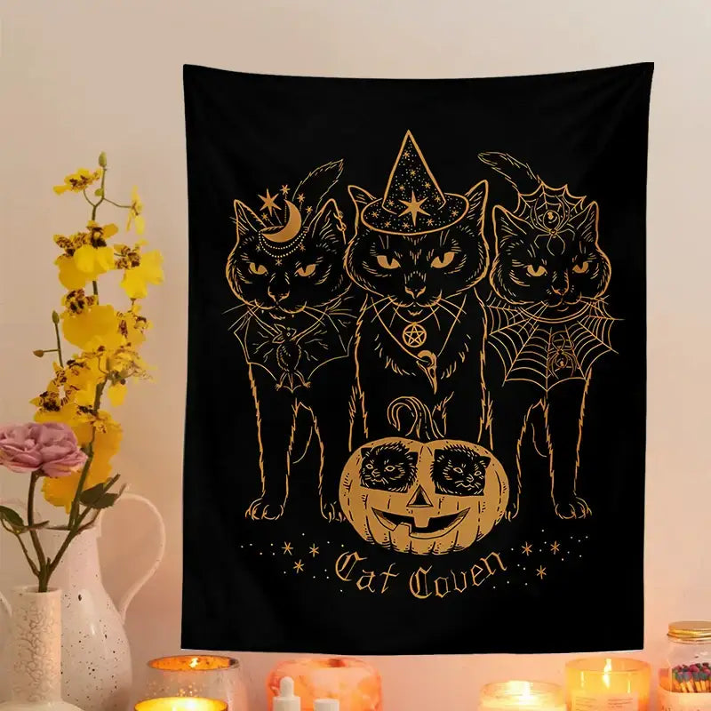 Black tapestry decorbites cat coven featuring three gold foil outlined cats in witchcraft attire with pumpkin detail