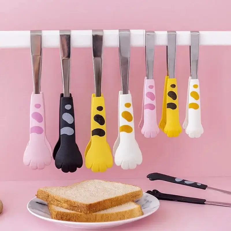 Cat paw stainless steel food tongs with silicone coating in pink black yellow and white spot patterns for kitchen use