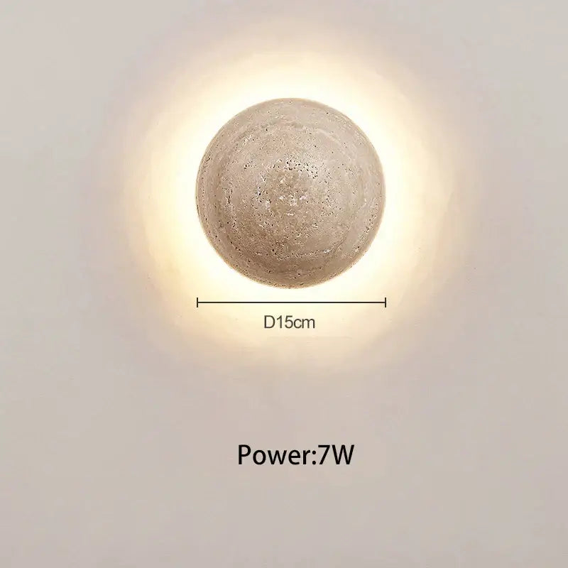 A round textured concrete wall lamp with cave stone yellow finish providing warm bedroom ambiance decorbites cave stone