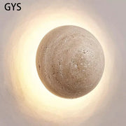 Beige textured stone sphere wall lamp with warm diffused glow for bedroom ambiance by decorbites cave stone yellow