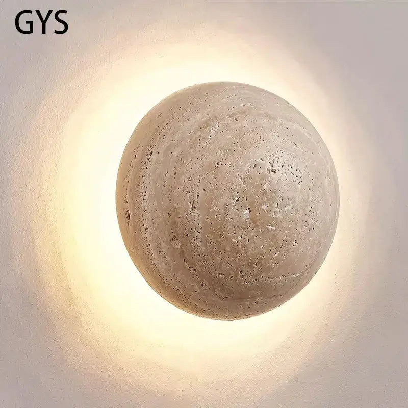 Beige textured stone sphere wall lamp with warm diffused glow for bedroom ambiance by decorbites cave stone yellow