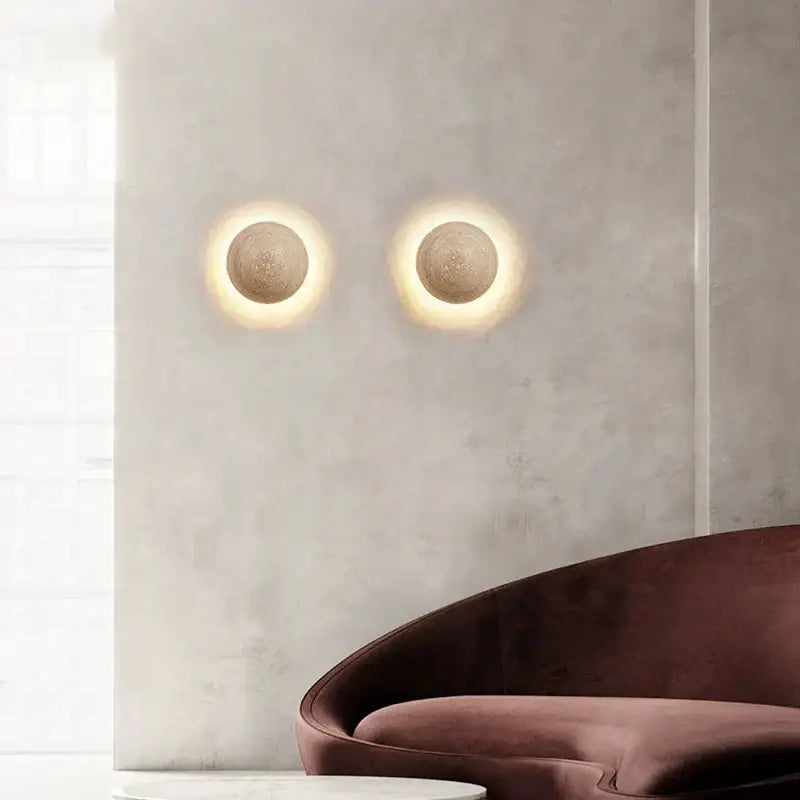 Two cave stone yellow textured sphere wall lamps from decorbites emit warm halo light for bedroom ambiance decor