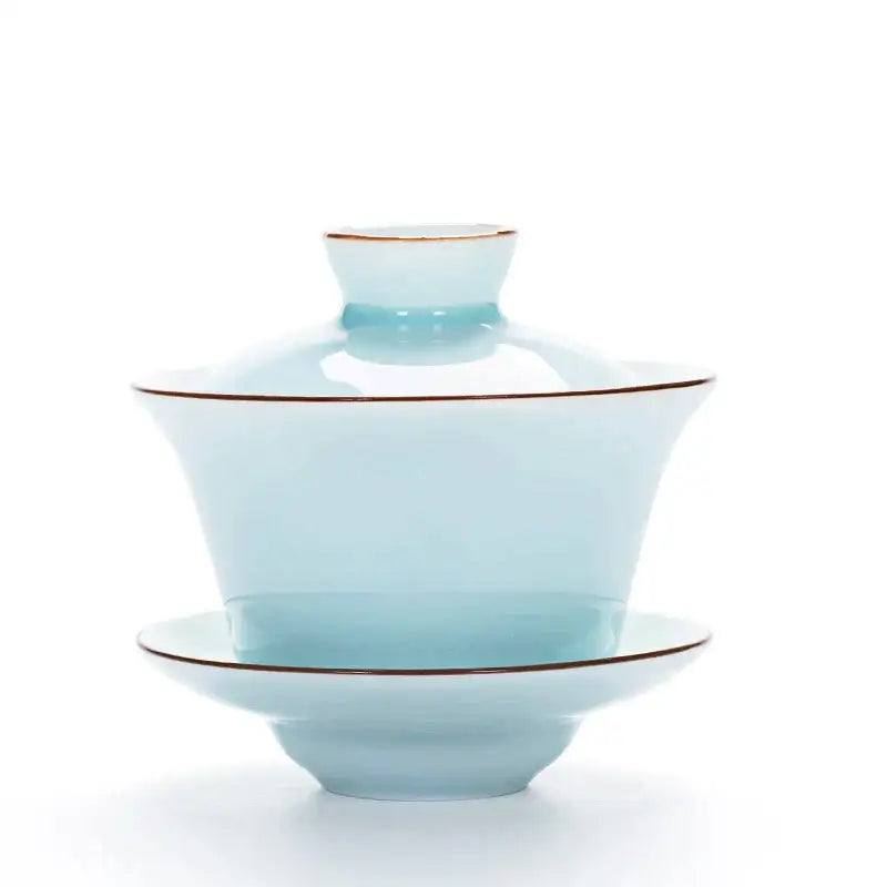A delicate celadon tea tureen ceramic tea set with light blue color and subtle gold rims for dining room use