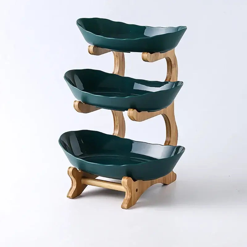Three-tiered ceramic and teal table plates set with leaf-shaped bowls and bamboo supports for dining room use