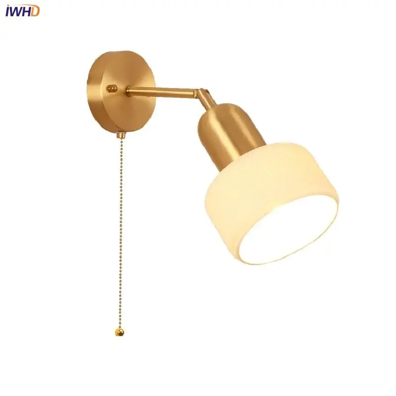 Gold-finished ceramic art wall lamp with adjustable arm and cylindrical frosted glass shade for bedroom reading light