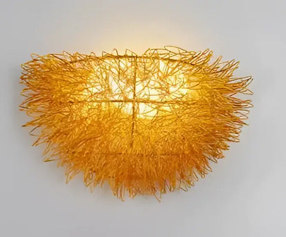 Golden intricately woven wire led wall lamp with warm glow ceramic bird and golden nest bedroom sconce