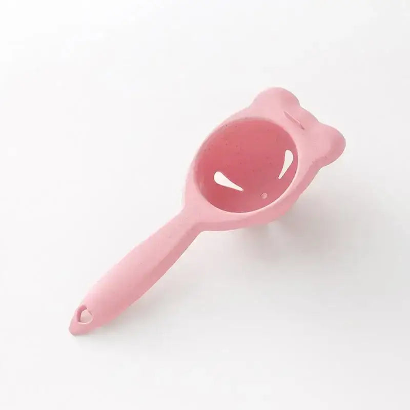 Pink silicone cat-shaped egg holder separator with rounded ears and whisker cutouts for decorbites boiled eggs