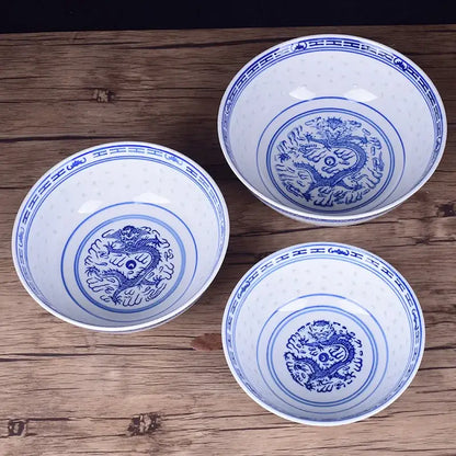 Three white ceramic dragon print nested bowls with blue decorbites ceramic dragon motifs for dining room decor