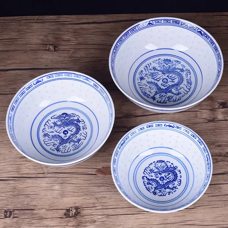 Three white ceramic dragon print nested bowls with blue decorbites ceramic dragon motifs for dining room decor