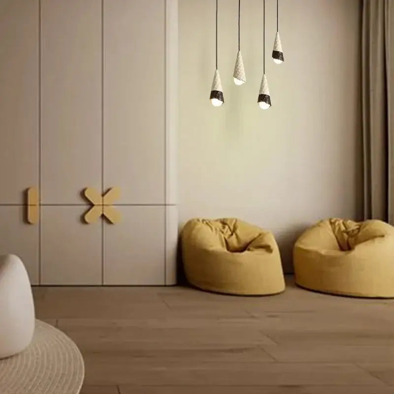 Three conical ceramic ice cream pendant lights with textured white bodies and black patterned bases with led bulbs