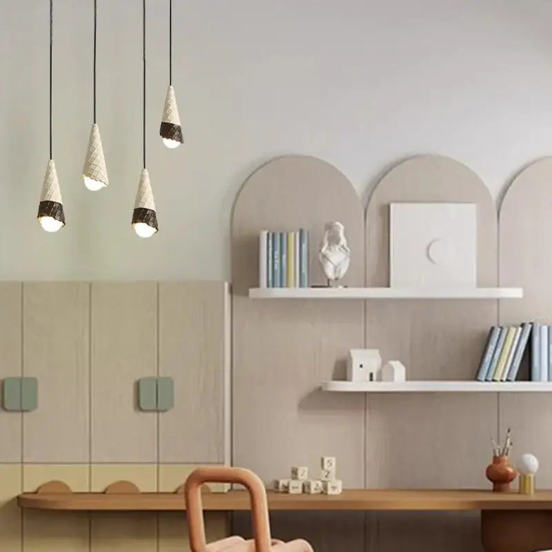 Three modern ceramic ice cream pendant lights with white shades and wrought iron bases for nursery lighting