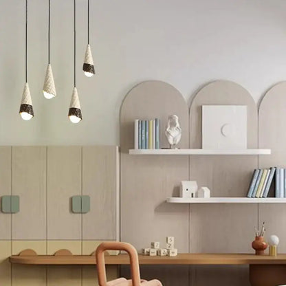 Three modern ceramic ice cream pendant lights with white shades and wrought iron bases for nursery lighting
