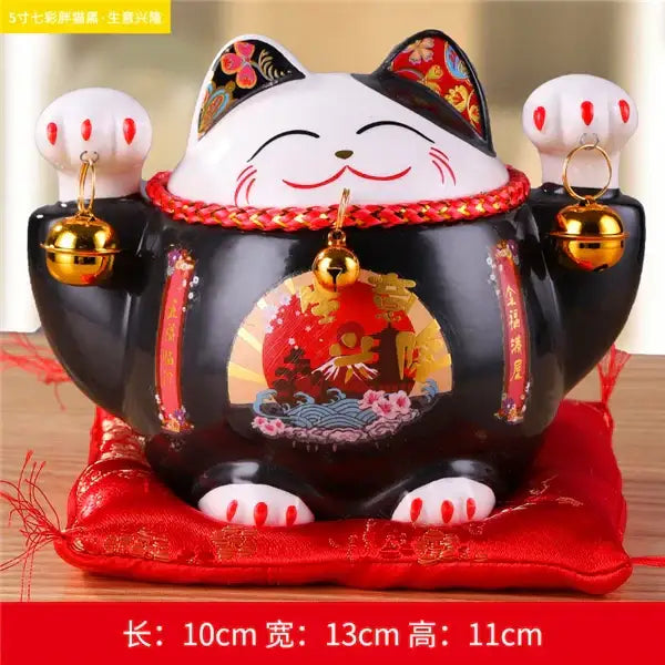 Black ceramic maneki neko piggy bank with white paws red accents and gold bells for decorbites ceramic maneki decor