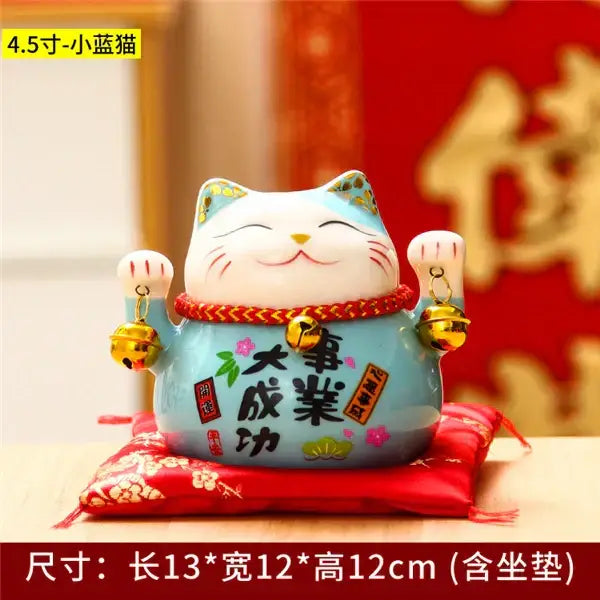 A light blue ceramic maneki neko piggy bank with smiling face red collar floral designs for living room decorbites ceramic maneki