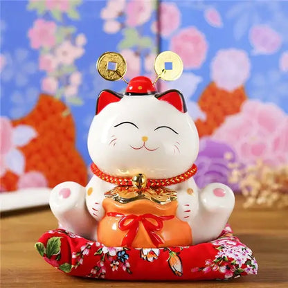 White ceramic maneki neko piggy bank with gold coins and red pouch for floral living room decorbites ceramic maneki