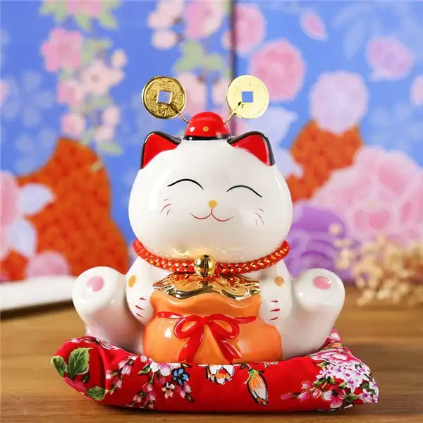 White ceramic maneki neko piggy bank with gold coins and red pouch for floral living room decorbites ceramic maneki