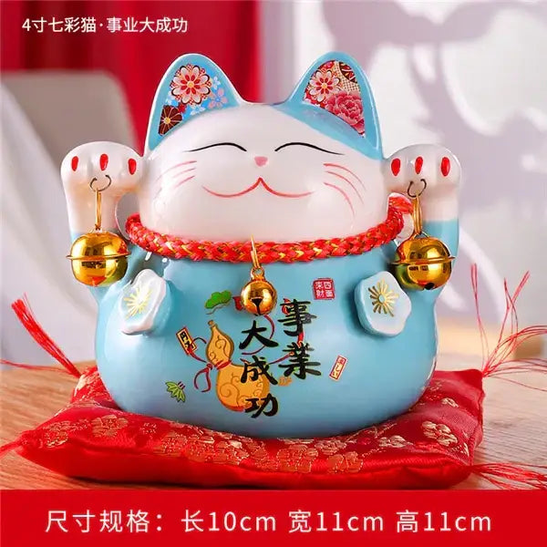 Ceramic maneki neko piggy bank with white face blue body gold and red decor holding golden bells for living room decor