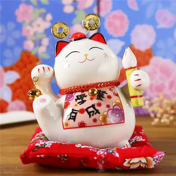 White ceramic maneki neko piggy bank with red accents gold coins and decorative bib for living room decorbites ceramic maneki