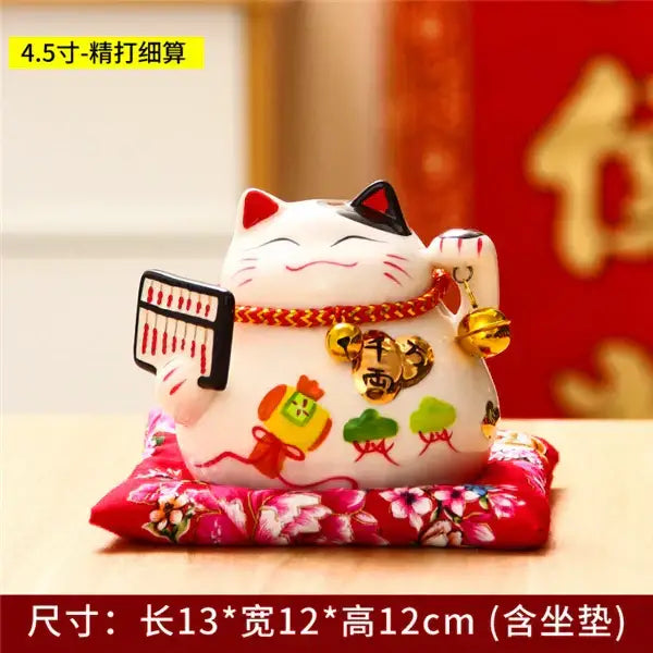White ceramic maneki neko piggy bank with black ears red accents and gold coins for living room decor by decorbites ceramic maneki