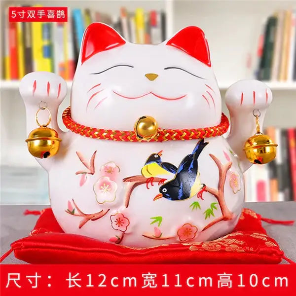 White ceramic lucky cat piggy bank with red accents and floral bird design from decorbites ceramic maneki neko decor