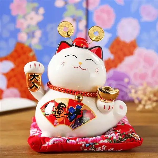 White ceramic maneki neko piggy bank with red accents gold coins and golden ingot for living room decor by decorbites