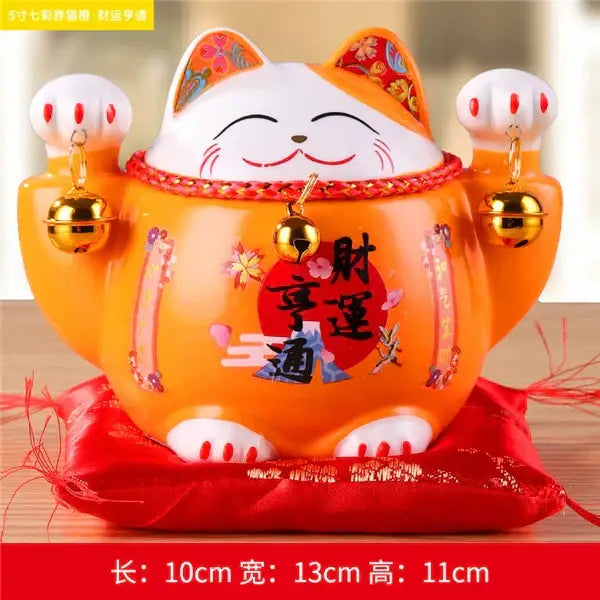 Orange ceramic maneki neko piggy bank with white accents and gold bells for decorbites ceramic maneki living room decor