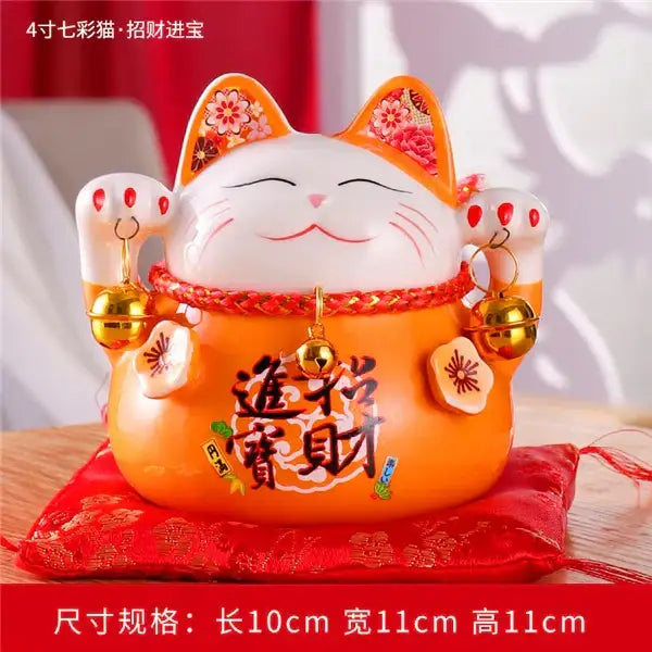 Orange ceramic maneki neko piggy bank with floral-patterned ears red rope belt and golden bells for living room decorbites decor