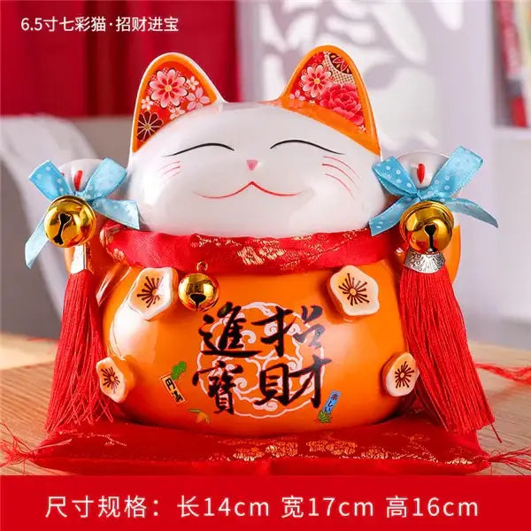 Orange ceramic maneki neko piggy bank with white face red ribbon and blue bows floral living room decor by decorbites