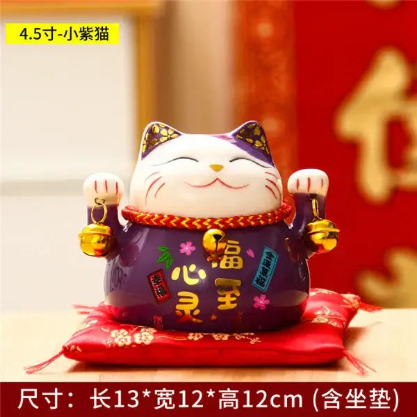 Purple ceramic maneki neko piggy bank with gold accents and red collar featuring chinese characters for decorbites ceramic maneki