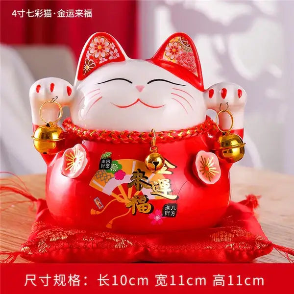 Red ceramic maneki neko piggy bank with white face gold bells and floral patterns for decorbites ceramic maneki decor