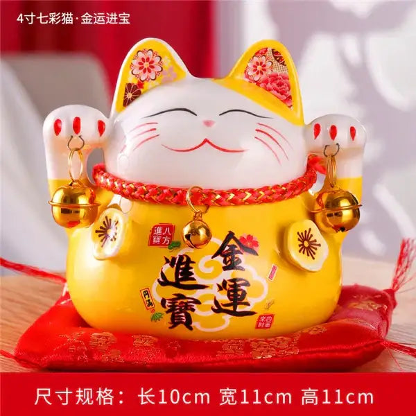 Yellow ceramic maneki neko piggy bank with white face red embroidered collar and bell charms for living room decorbites ceramic maneki