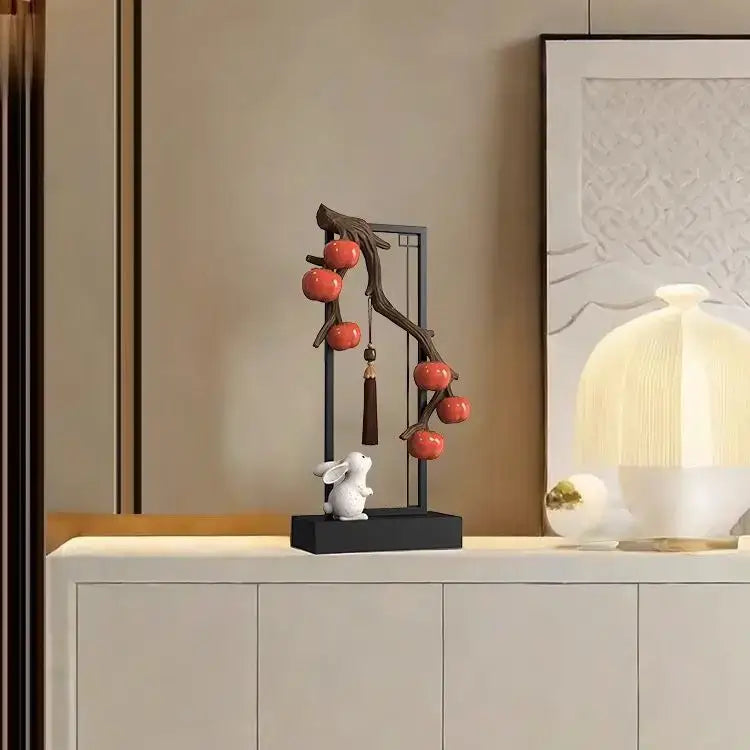 Ceramic home decor set with a white rabbit under a black metal frame featuring red persimmon for living room display
