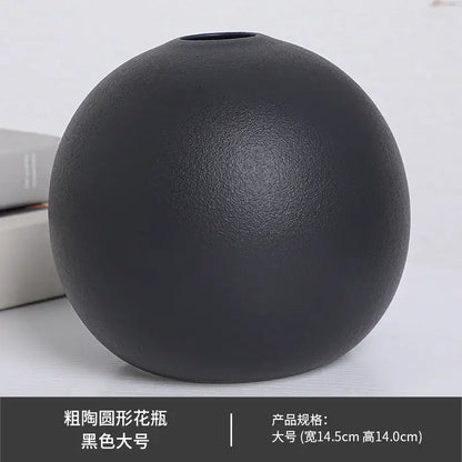 A matte black ceramic round vase with a slightly textured surface and small opening from the ceramic round vase black white collection