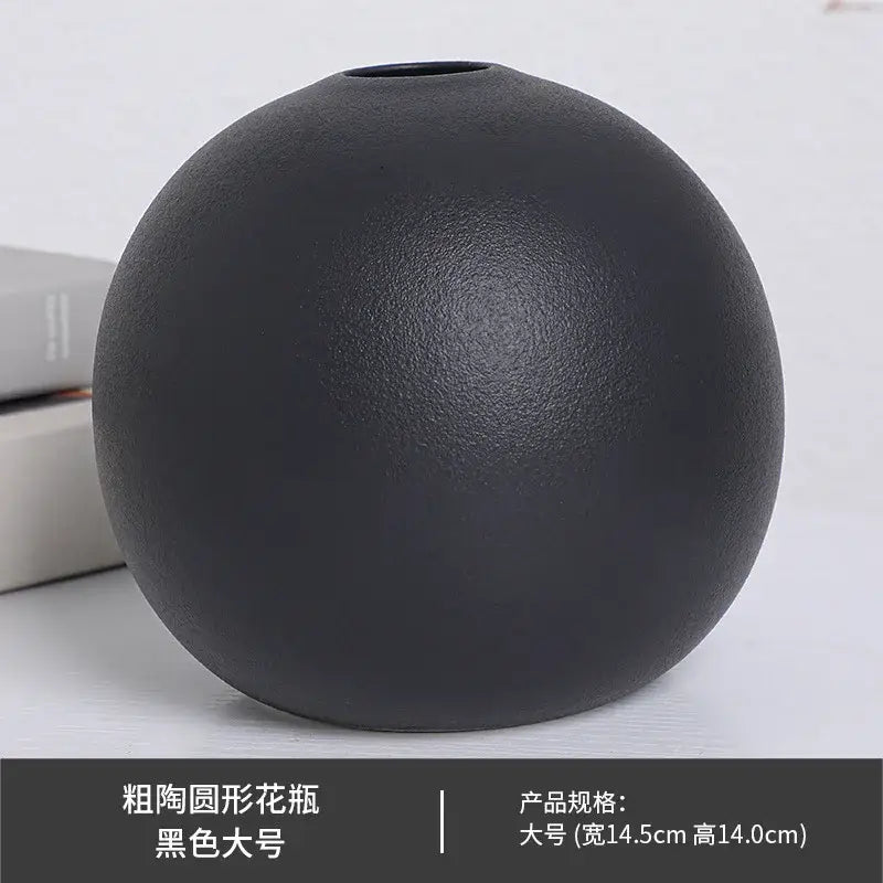 A matte black ceramic round vase with a slightly textured surface and small opening from the ceramic round vase black white collection