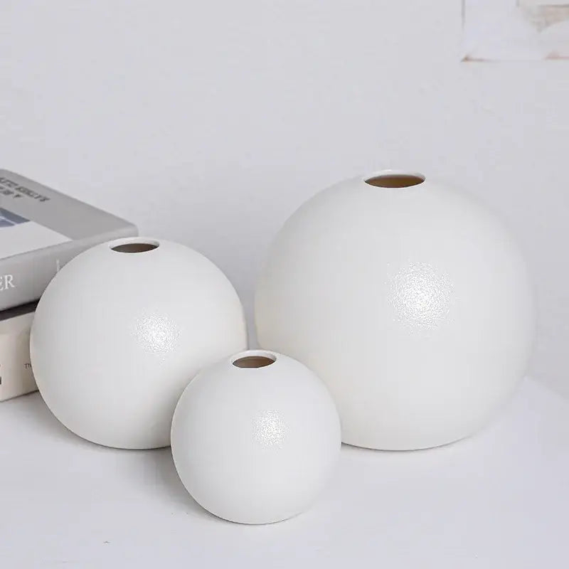 Set of three minimalist ceramic round vases black white with smooth glossy finishes and uniform circular openings