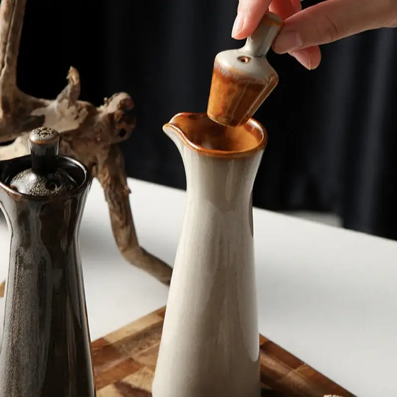 A ceramic seasoning pot with a tapered body and amber-brown glazed rim from decorbites ceramic seasoning set