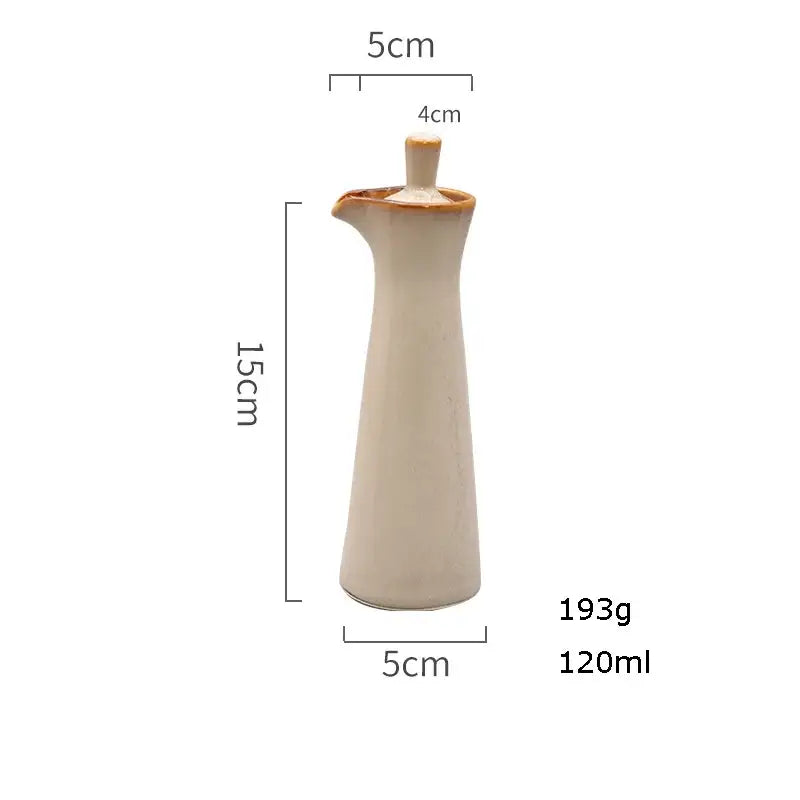 Cream-colored ceramic seasoning pot with tapered body narrow spout and wooden stopper by decorbites ceramic seasoning