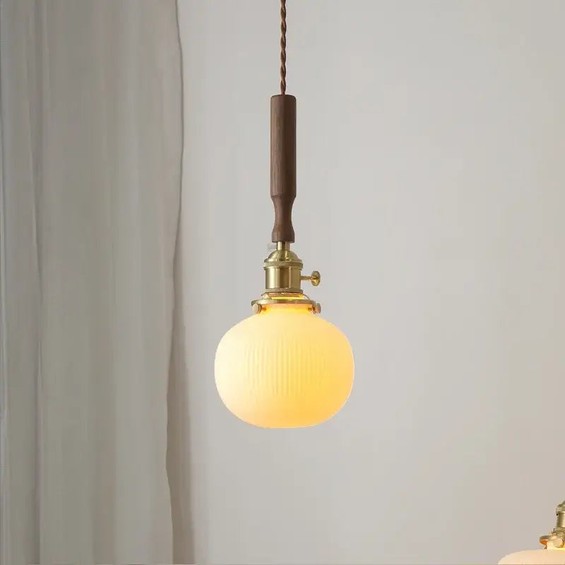 Warm-toned ceramic walnut copper ribbed glass pendant light with brass fixture and dark wood handle for bedroom decorbites pendant light